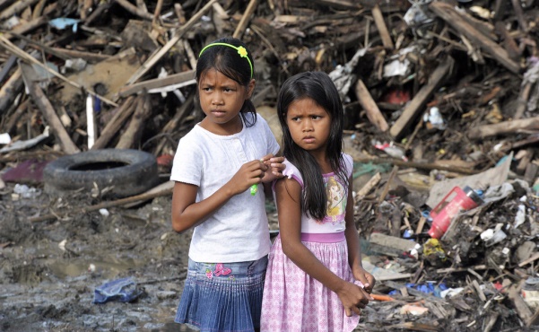 Two girls look out over debris in the Philippines following Typhoon Haiyan. Photo: Courtesy of Global Partnership for Effective Development Co-operation  
