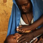 An infant is vaccinated against polio in the town of Kabkabia in North Darfur State. Photo credit: © UNICEF/NYHQ2006-0565/Noorani