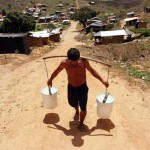 A man hauls water at the Chico Mendes landless peasant camp in Pernambuco, Brazil. Credit: Alejandro Arigón/IPS